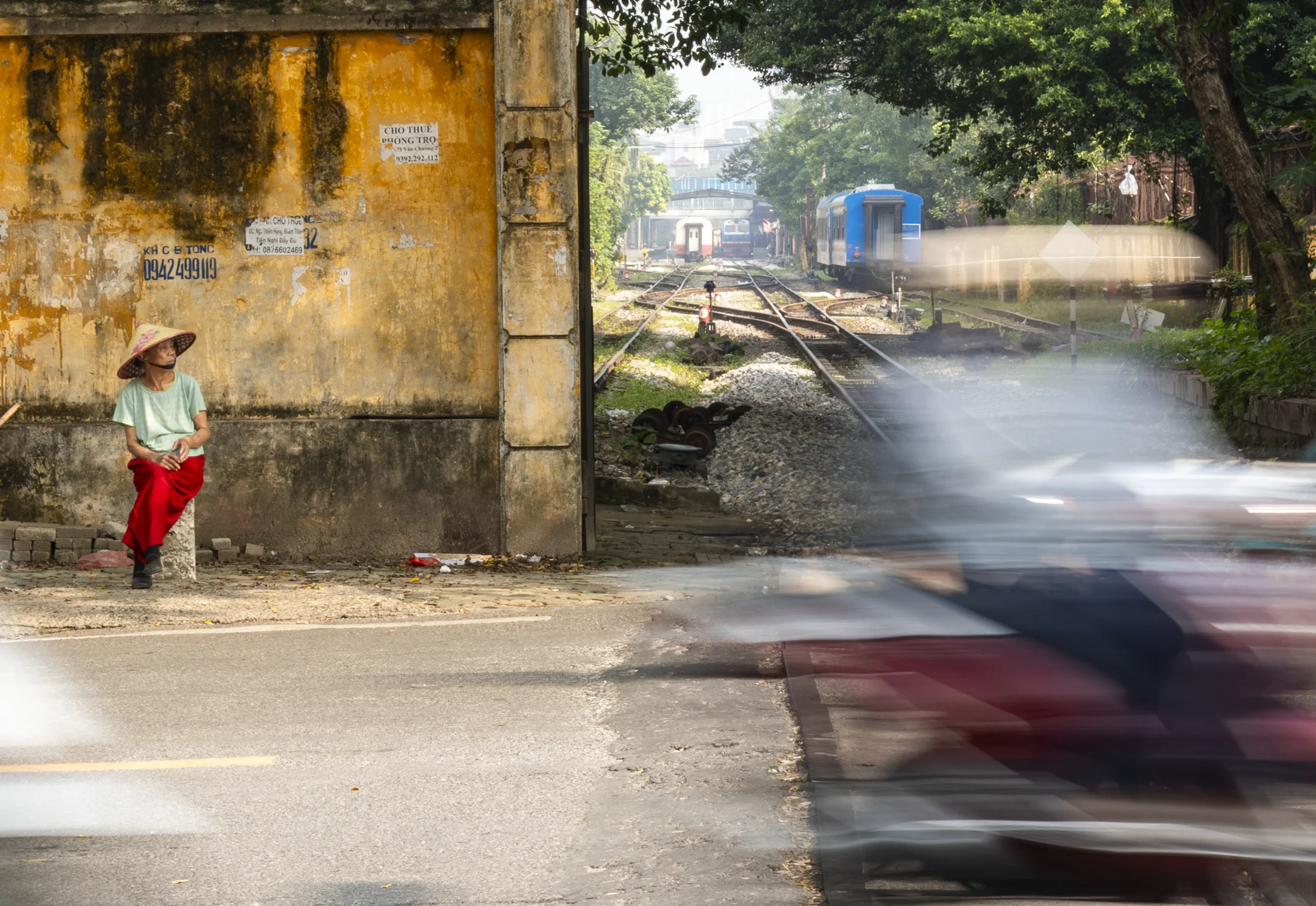 Motorbike passing beside the railway in Hanoi, Vietnam