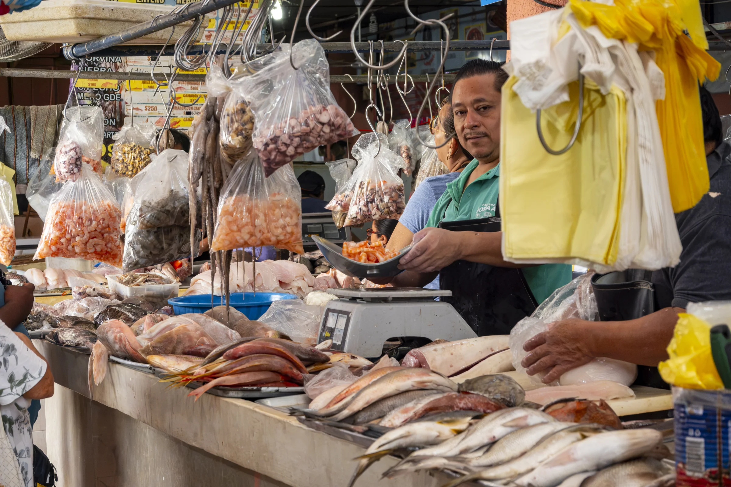 Fish seller working at a market stall in Mexico